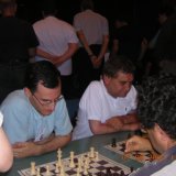 11 Eric Huber and Ion Murarasu studying the chess board, while Panagis Sklavounos is ready to make his move